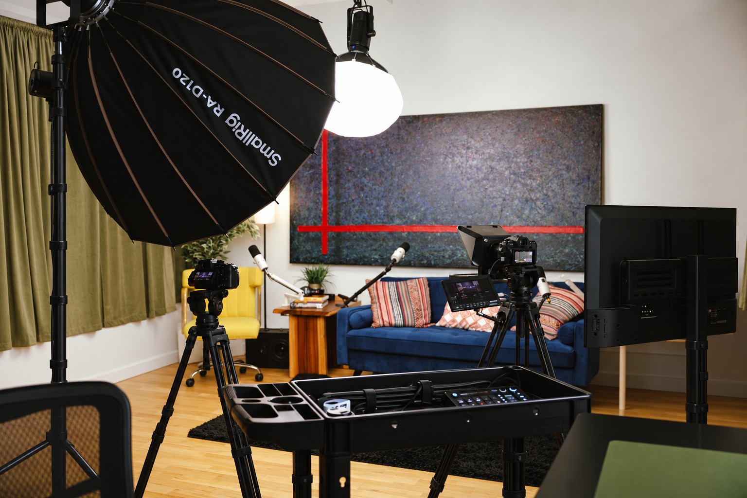 XYZ Studios Chicago living room set with yellow seating, a blue sofa, cameras and studio lighting